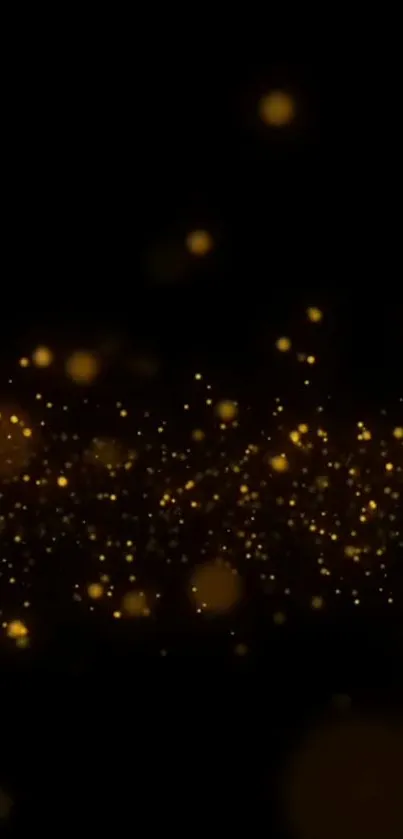 Golden sparkling particles on black background wallpaper.