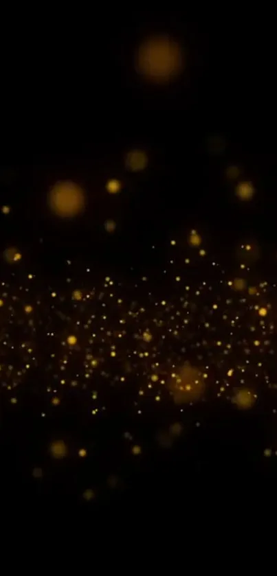 Golden sparkles on black background wallpaper for mobile phones.