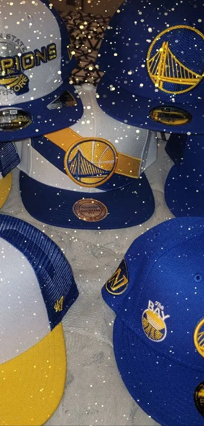 Golden State Warriors caps in blue and gold displayed on a bed.