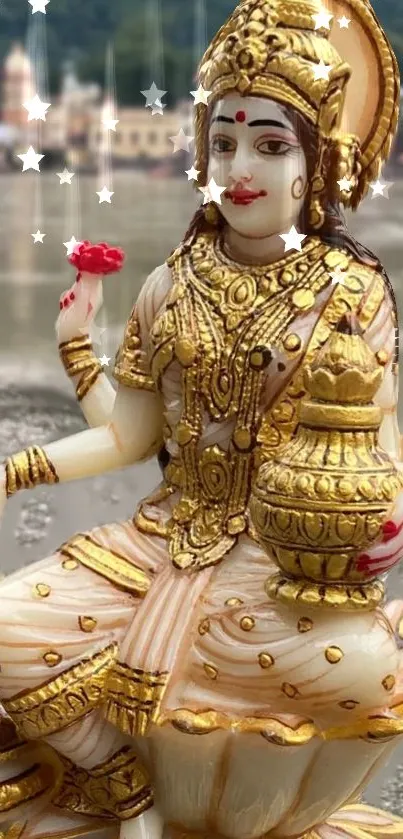 Golden statue seated on lotus with vibrant details.