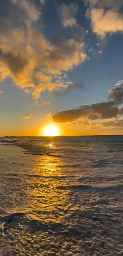 Golden sunset over ocean waves and beach.