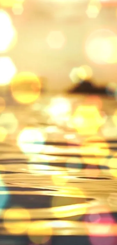 Golden bokeh wallpaper with sunset reflections and soft ripples.