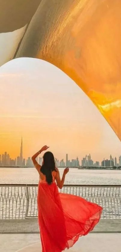 Woman in red dress at sunset overlooking city skyline and sea.