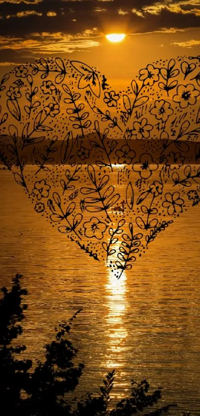 Floral heart silhouette against a glowing sunset over calm waters.