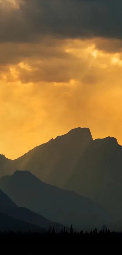 Golden sunset behind mountain silhouettes wallpaper.