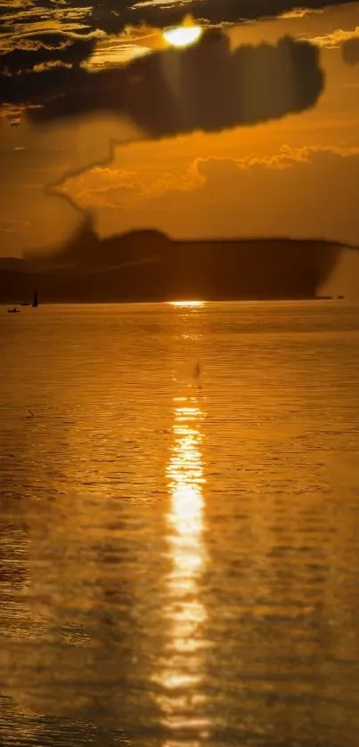 Golden sunset over an ocean with serene reflections.