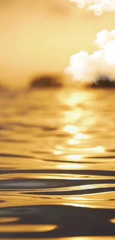 Golden sunset reflected over calm rippling water with white clouds.