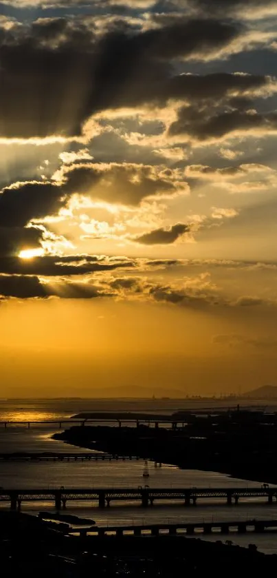 Golden sunset casting rays over urban cityscape and bridges.