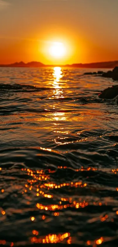 A breathtaking golden sunset over the ocean with calm waves and vivid colors.