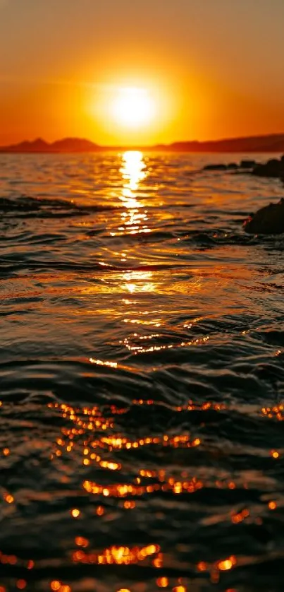 Golden sunset reflecting on ocean waves creating a serene scene.