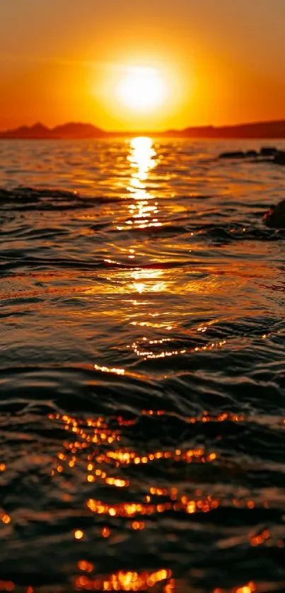 Golden sunset casting reflections over ocean waves.