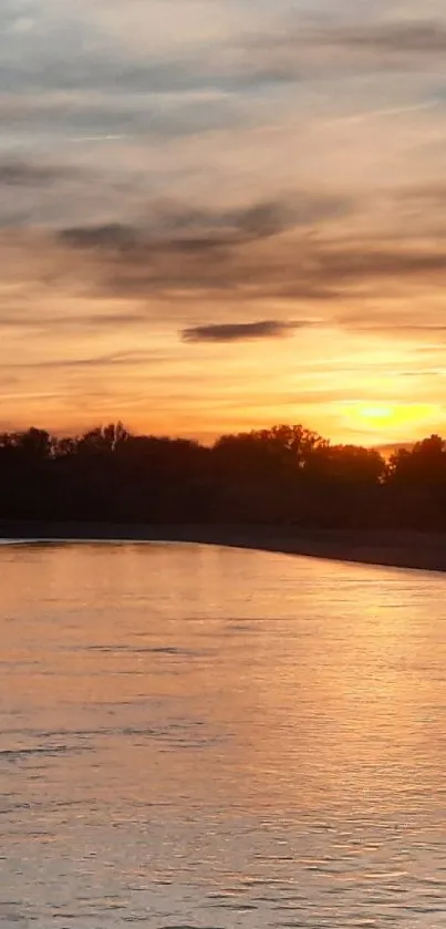 Serene golden sunset over a tranquil river scene with calm waters.