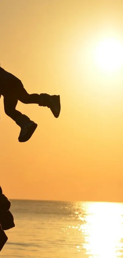 Silhouette of child in golden sunset over ocean