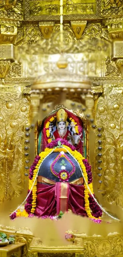 Golden temple deity adorned with floral garlands in vibrant colors.