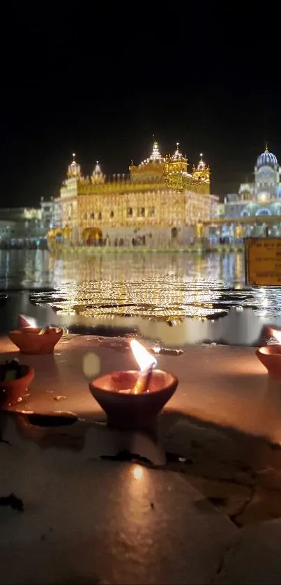 Golden Temple illuminated at night with reflection in water and glowing diyas.