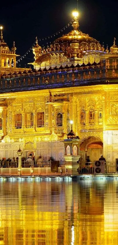 Golden Temple lit up at night with water reflection.