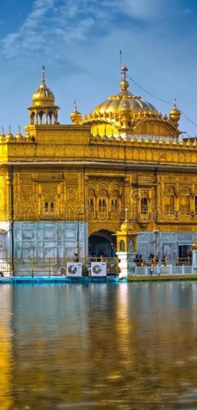 Golden Temple reflecting in calm waters under a clear blue sky.