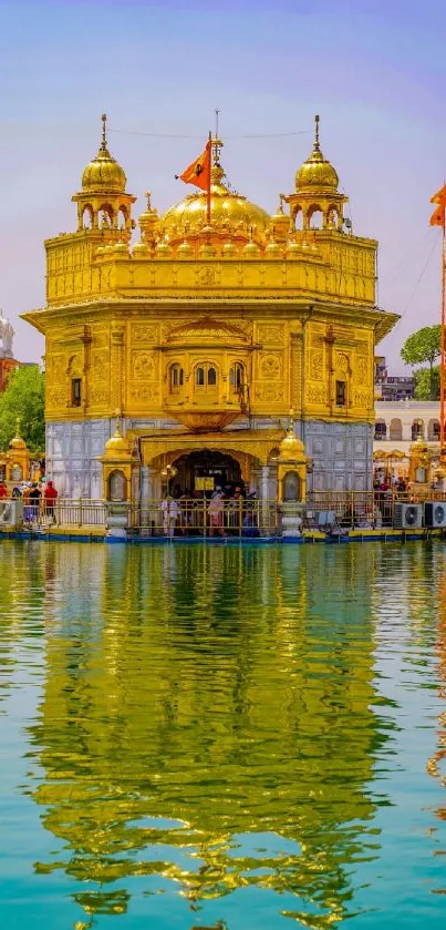 Golden Temple reflecting in calm water under a bright sky.