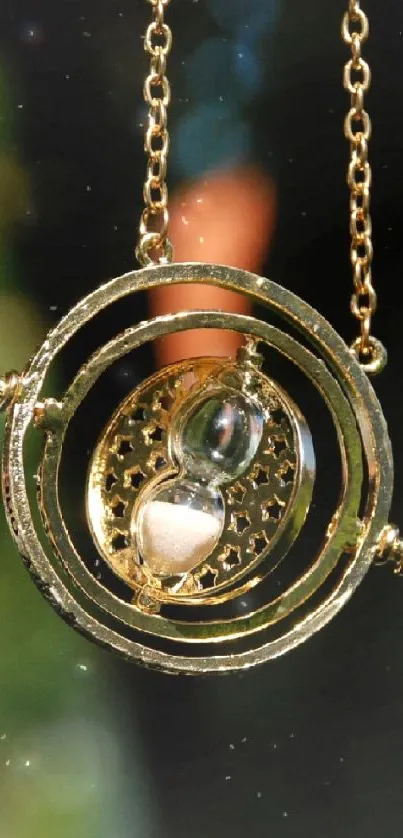 Golden time necklace pendant on blurred background.