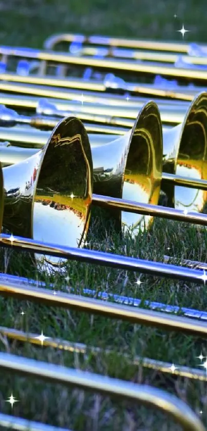 Golden trombones neatly arranged on grass, exuding a musical vibe.