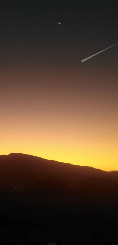 Mountain silhouette with golden twilight sky and serene ambiance.