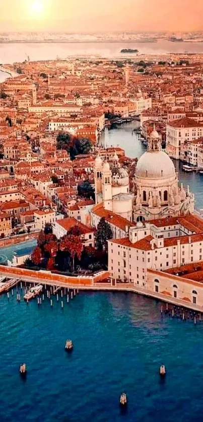 Aerial view of Venice at sunset with golden hues and historic architecture.