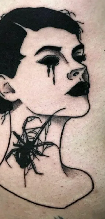 Gothic-style tattoo in bold black ink on beige skin backdrop.