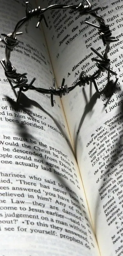 Gothic crown of thorns shadow on open book.