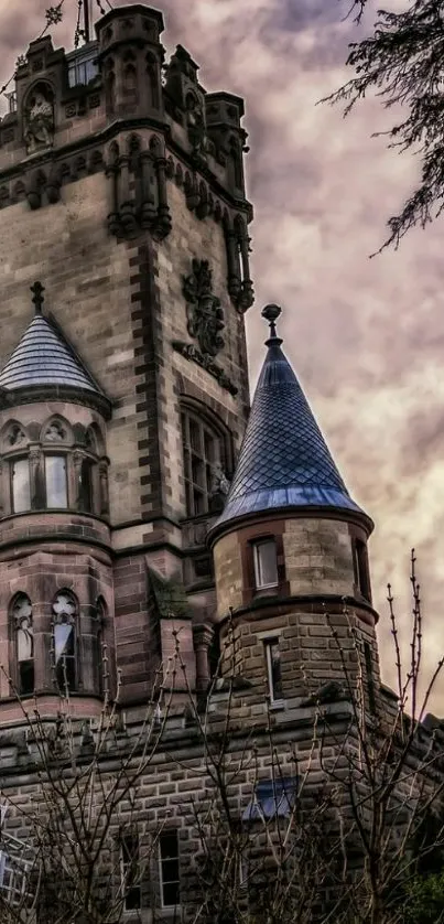 A gothic castle tower against a moody sunset sky.