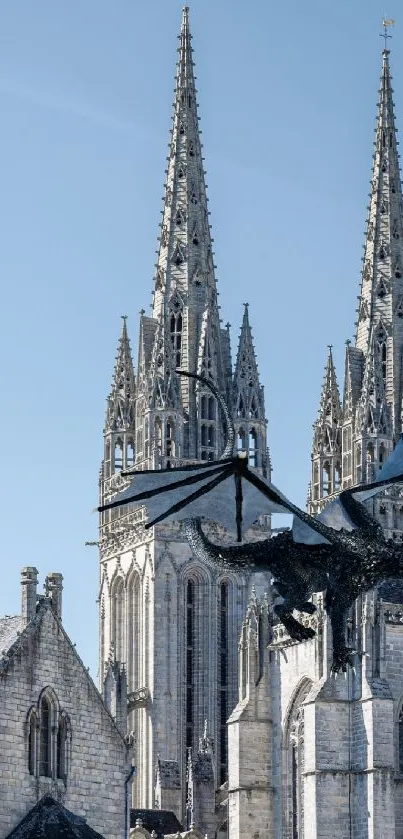 Gothic cathedral towers with an overhead dragon under a blue sky.