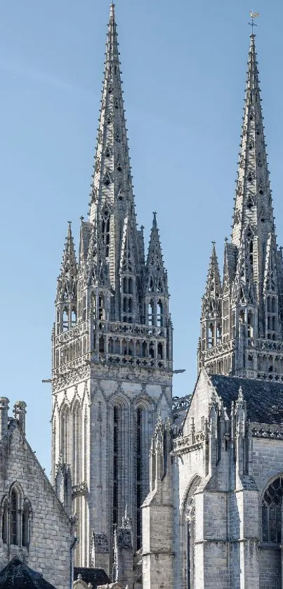 Gothic cathedral with towering spires against a clear blue sky.