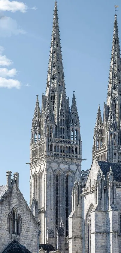 Gothic cathedral spires against a clear blue sky.