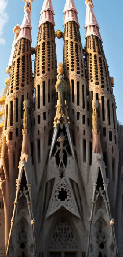 Gothic cathedral with spires against a clear blue sky wallpaper.