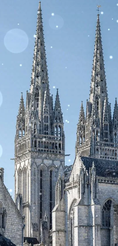 Gothic cathedral with tall spires against a clear blue sky.