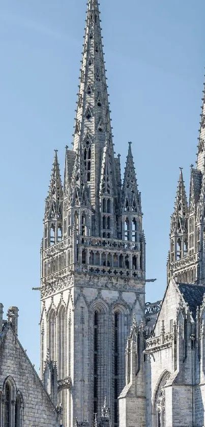 Gothic cathedral spires against blue sky.