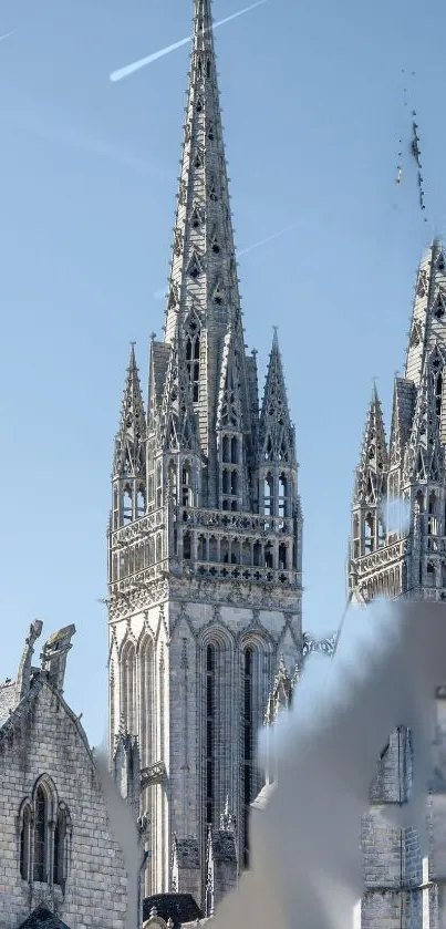 Gothic cathedral spires against a blue sky.