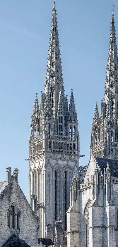 Gothic cathedral towers under a clear sky.