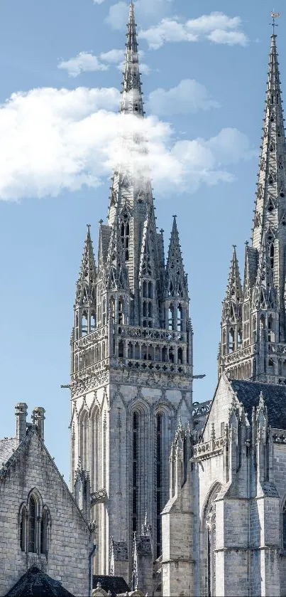 Gothic cathedral with tall stone towers against a clear blue sky backdrop.