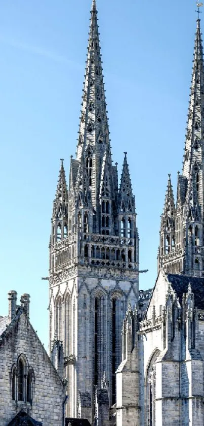 Gothic cathedral spires against blue sky.