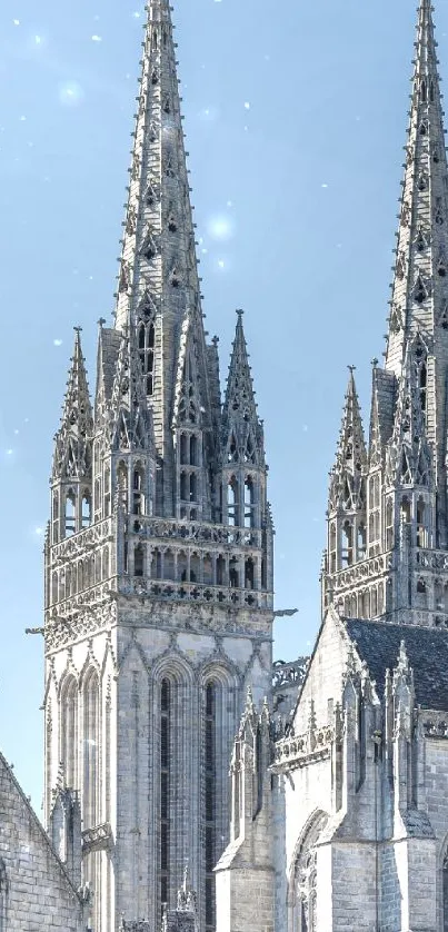 Gothic cathedral spires against a light blue sky.