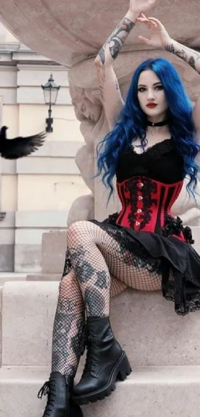 Gothic girl with blue hair and a red corset sitting on stone steps.