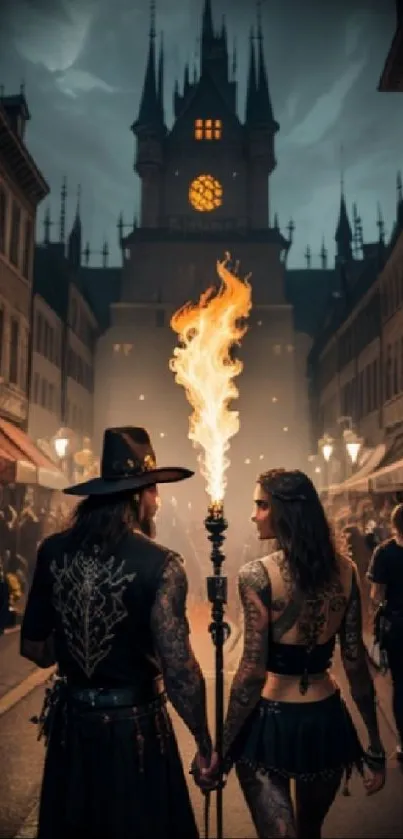 A gothic couple holding a fiery torch in a crowded, historic street at night.