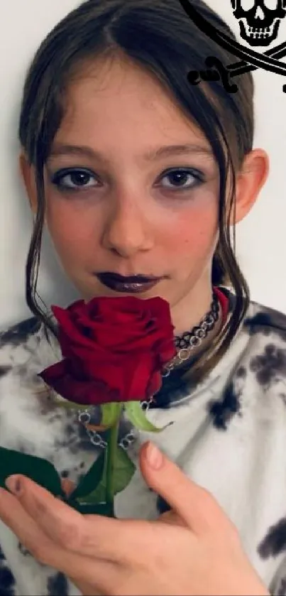 Gothic-themed youth holding a red rose in a minimalist setting.