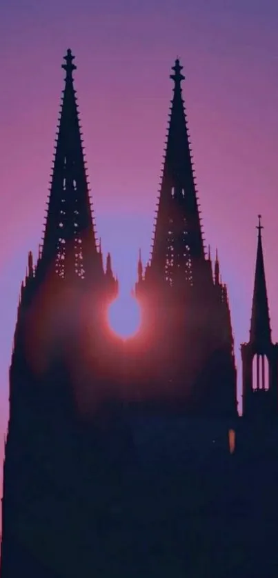 Gothic tower silhouette against a purple sunset.