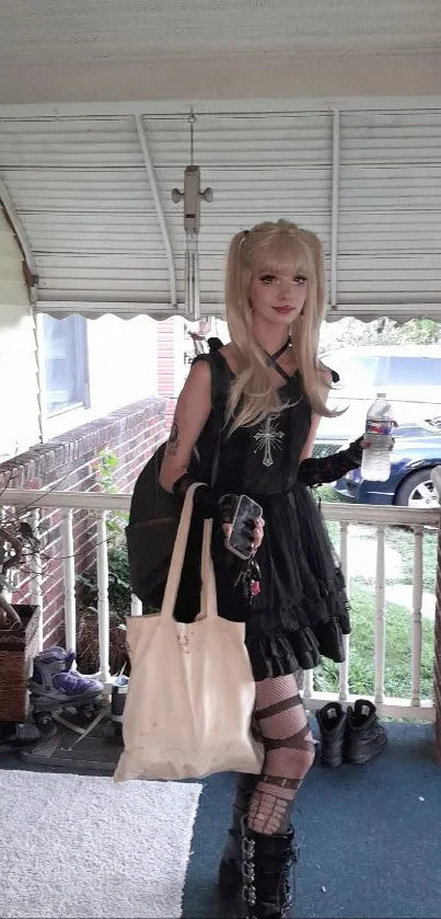 Gothic fashion on a porch with dark attire and accessories.