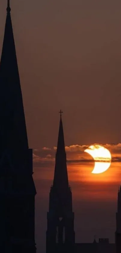 Gothic cathedral spires silhouetted against a vibrant sunrise.