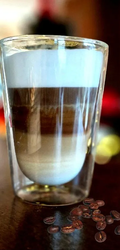 Aesthetic layered latte in glass with coffee beans.