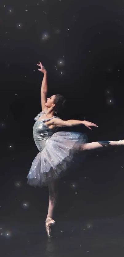 Ballet dancer performing on stage against a black background.