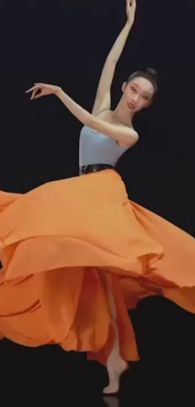 Ballerina dancing in vibrant orange skirt.