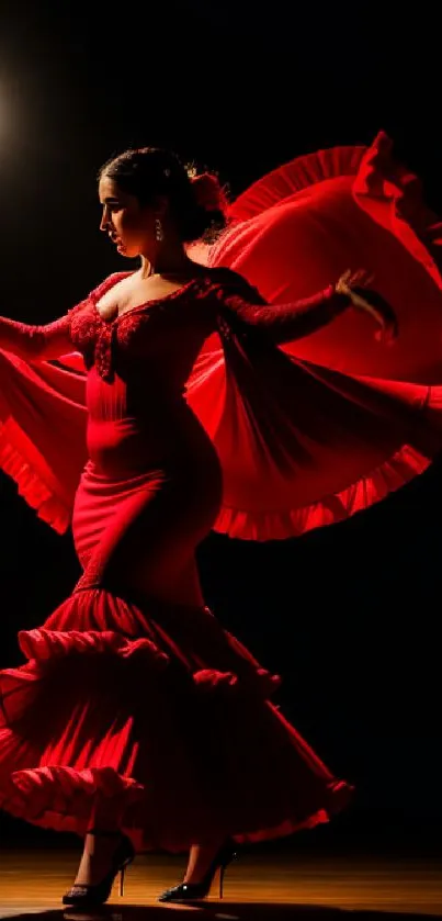 Flamenco dancer in red dress with dramatic spotlight on stage.